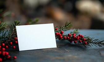 A white card is sitting on a table with red berries photo