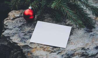 A white card with a red ornament on top of it photo
