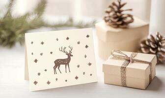 A white card with a deer on it sits on a table next to a white box photo