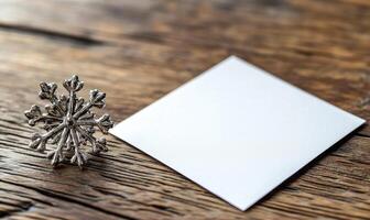 A snowflake sits on top of a white piece of paper photo