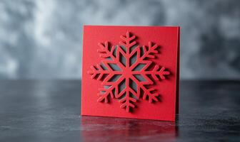 A red card with a snowflake design on it photo