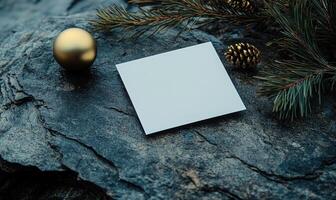 A white card with a gold ball on top of it photo