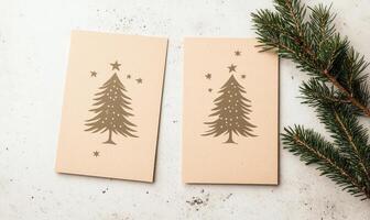 Two Christmas cards with a tree on them photo