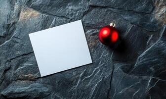 A white card with a red circle on it sits on a stone surface photo