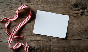 A white card with a red ribbon on top of it photo