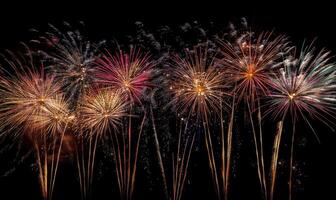 A row of fireworks are lit up in the sky photo
