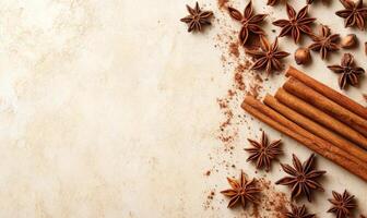 A white background with a bunch of cinnamon sticks and some star anise photo