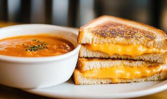 A plate of food with a sandwich and a bowl of soup photo