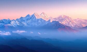 The mountains are covered in snow and the sky is a beautiful shade of pink photo