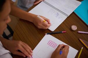 Students collaborating on math homework at a wooden table photo