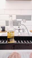 A bottle of beer sitting on a sink photo