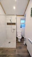 A bathroom with a toilet, shower and a sink photo
