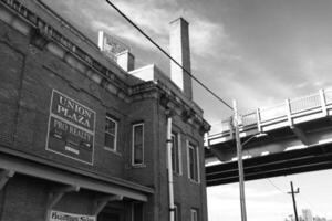A black and white photo of a brick building