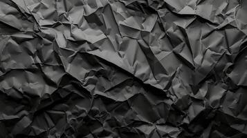Black crumpled paper texture background with empty space for text photo