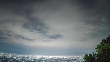 Night view of the city from the top of the mountain. Night sky with clouds. photo