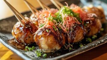 Plate of Freshly Made Takoyaki with Sauces and Bonito Flakes photo