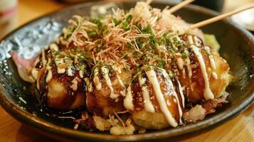 Plate of Freshly Made Takoyaki with Sauces and Bonito Flakes photo
