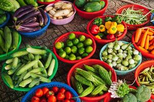 Various vegetables and herbs on the market in baskets. photo