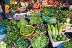 Various vegetables and herbs on the market in baskets. photo