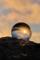 The landscape view on a nature through a glass ball with a blurred background creative photography photo