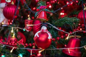 front view for christmas tree with focus on it is red decorations photo