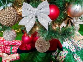 Lovely christmas tree with beautifuly packed presents and boxes under it photo