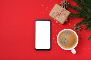 Modern smartphone with mockup on red background with christmas decoration. Flat lay template photo