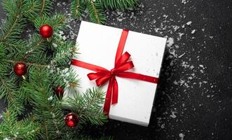 Christmas, New Year black stylish background with a branch of fir tree snow and snowflakes photo