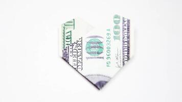 A folded dollar bill with a heart shape video