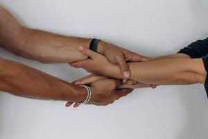 Two hands hold tightly to each other, rescuer saves, pulls out of trouble a person in need of help photo