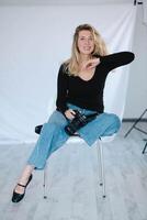 A girl model elegantly posing in front of the camera, capturing the attention of the photographer with her vibrant expressions photo