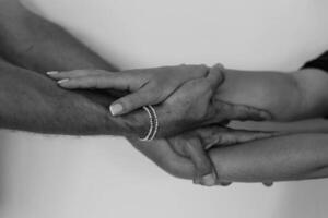 Two hands hold tightly to each other, rescuer saves, pulls out of trouble a person in need of help photo