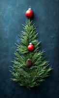 A Christmas tree made of pine needles and a red ball. The pine needles are arranged in a way that resembles a tree, and the red ball is placed on top of the tree photo