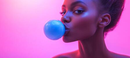 A woman is blowing bubbles with a blue bubblegum. The image has a bright and colorful mood, with the pink background and the blue bubblegum. The woman's expression is playful and carefree photo