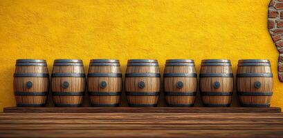 A row of wooden barrels are lined up against a yellow wall. The barrels are old and have a rustic appearance. The scene gives off a sense of history and tradition photo