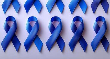 A series of blue ribbons are arranged in a row on a white background. The ribbons are likely meant to represent a cause or support for a specific issue, such as breast cancer awareness photo