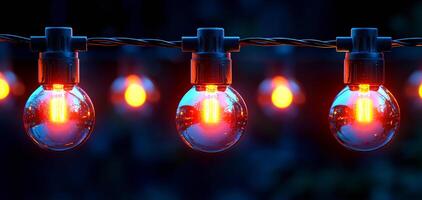 A string of lights with a blue background. The lights are orange and are hanging from a chain photo