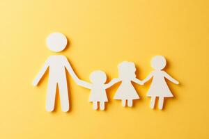 A family of four is holding hands, with a man in the middle. Concept of togetherness and love photo