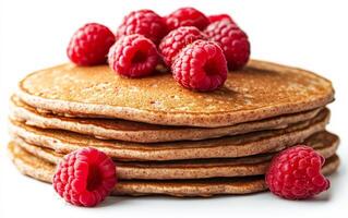 A stack of pancakes with raspberries on top. The pancakes are brown and fluffy, and the raspberries are red and juicy. Concept of indulgence and comfort photo