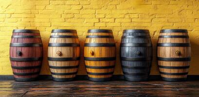 A row of wooden barrels with different colors and sizes. The barrels are arranged in a line and are placed on a wooden floor. Concept of variety and diversity photo