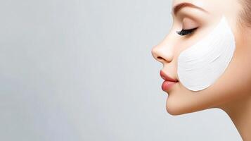 A woman with a white face mask on her face. The woman is smiling and looking at the camera photo