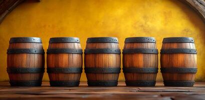 A row of five wooden barrels are lined up on a wooden floor. The barrels are all the same size and shape, and they are all brown. The scene has a rustic and traditional feel photo