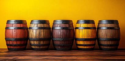 A row of wooden barrels with different colors and sizes. The barrels are arranged on a wooden shelf photo