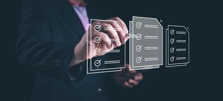 Businessman check electronic documents on digital documents and checklist approve, online evaluation of business on virtual interface, Communication technology concept. photo
