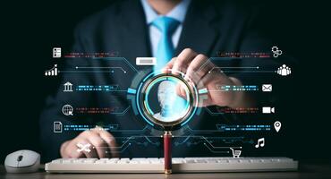 Businessman Searching for information in technology with AI systems concept, Businessman hand holding magnifying glass, chat and AI search engine for data by connect to global internet network. photo