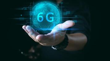 Businessman holding global network connection on 6G technology and futuristic advancement, uture technology 6G network internet of thinks connection communication, high-speed internet network signal. photo
