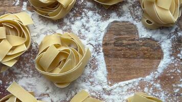 Chef making heart shape in flour with pasta around video