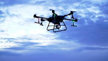 A small drone flying in the sky with a cloudy sky video