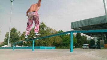 A man riding a skateboard on a rail video