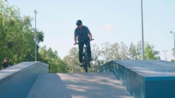 A man on a bike doing a trick on a ramp video
